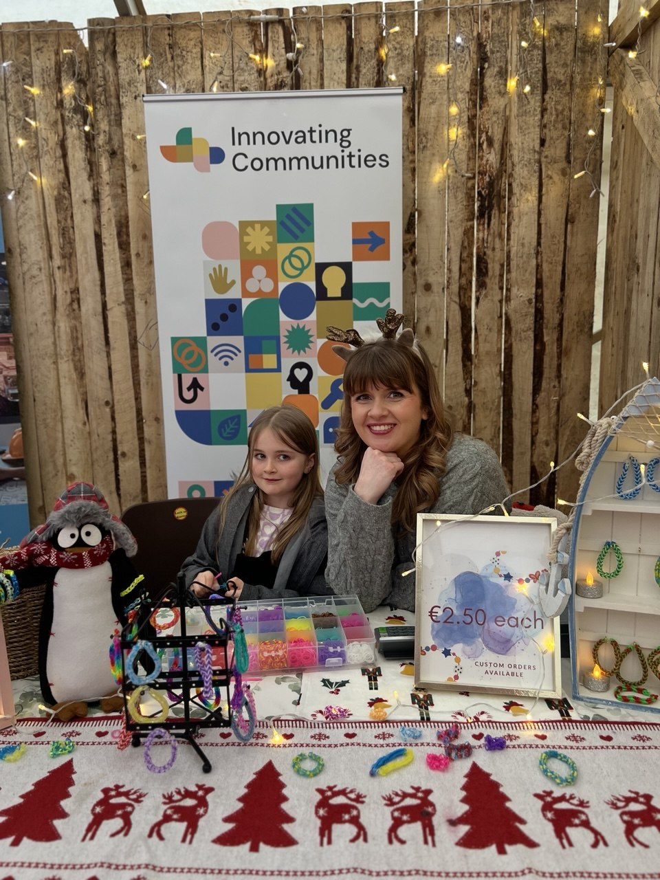 A young girl making loom band bracelets with her mum