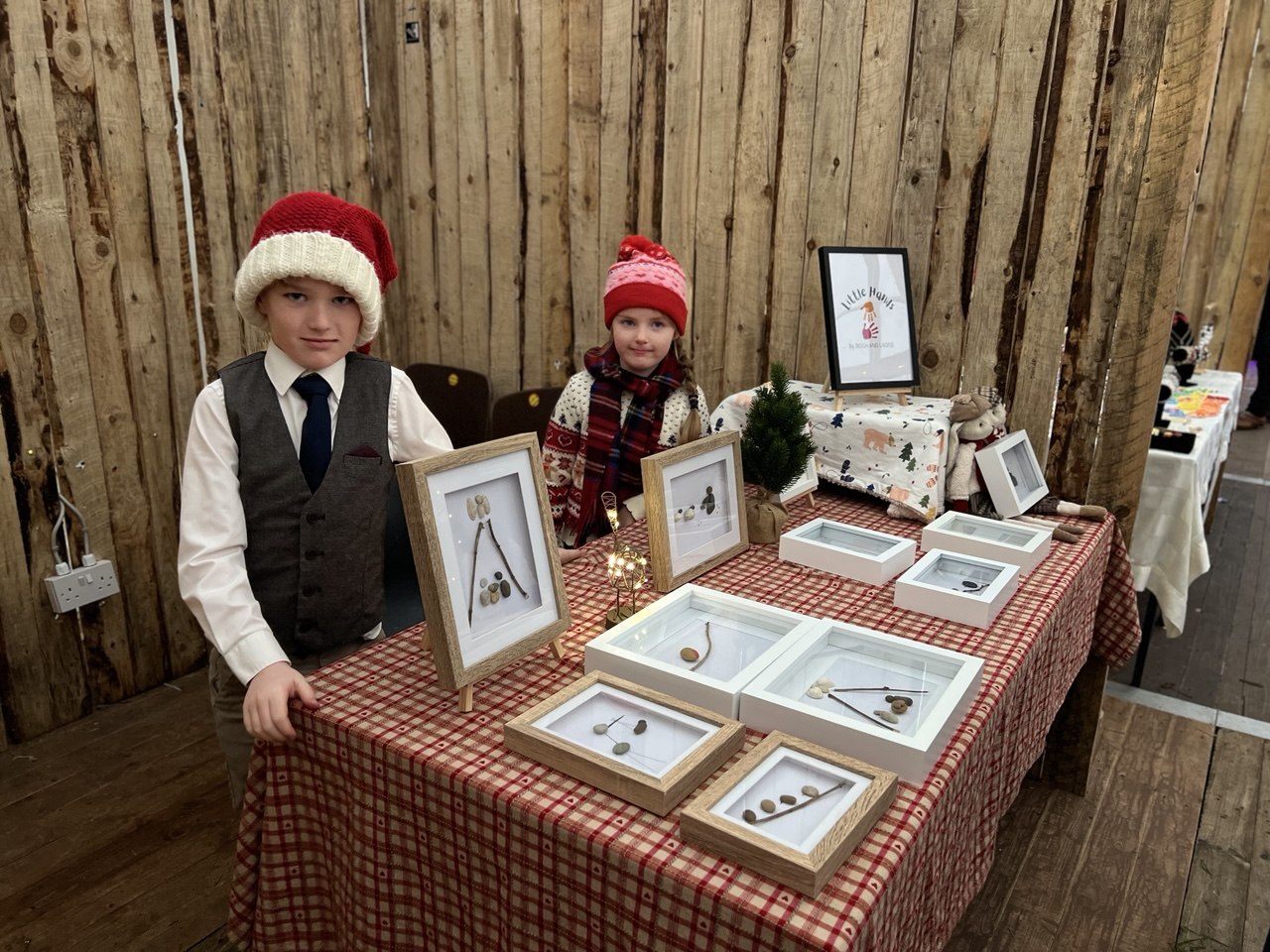A brother and sister with framed pebble art